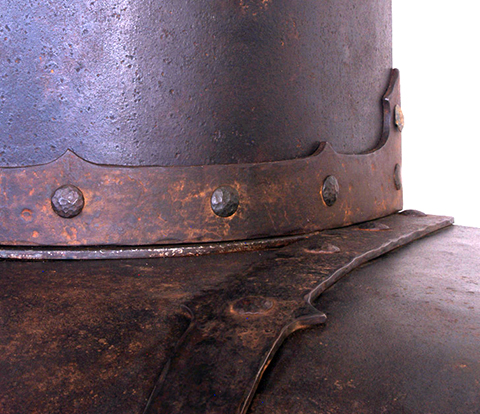 This distressed steel range hood in Spanish Revival style was done for a rustic home in Santa Fe, New Mexico and with a fireplace hood in a similar style. A "Rust Antique" finish has been carefully applied to the steel straps and panels.