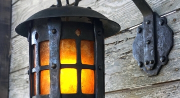 Forged wall-hanging steel lantern with amber mica. We used 1/4” thick steel to achieve that substantial character reminiscent of Japanese cast iron lanterns.⁣ The amber mica sheet, which provides a warm glow, is carefully bent into a tube for a tight custom fit.