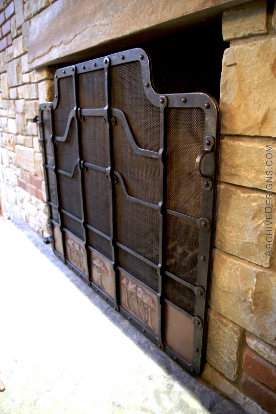 Wrought iron fire screen with copper panels and trees in repoussé