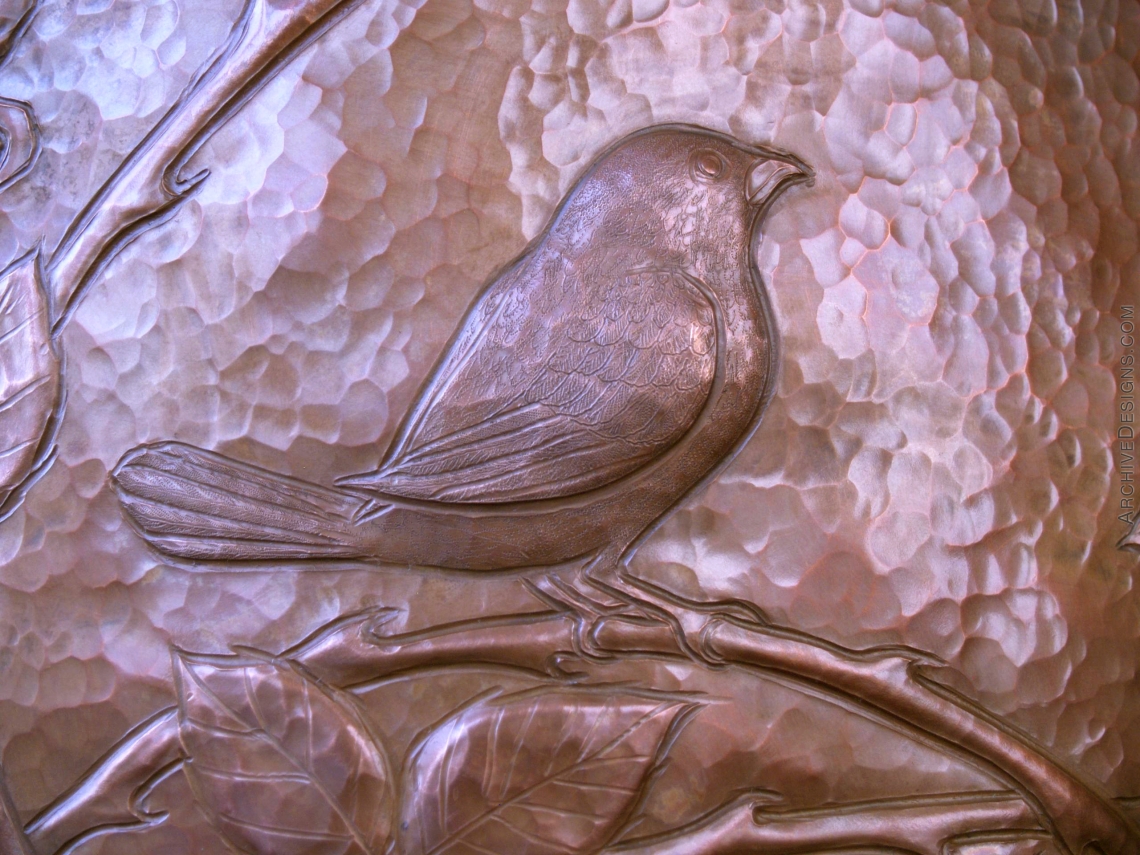An exquisitely engraved Blackcapped-Chickadee in repoussé occupies a thicket of wild roses on a hammered copper vessel.