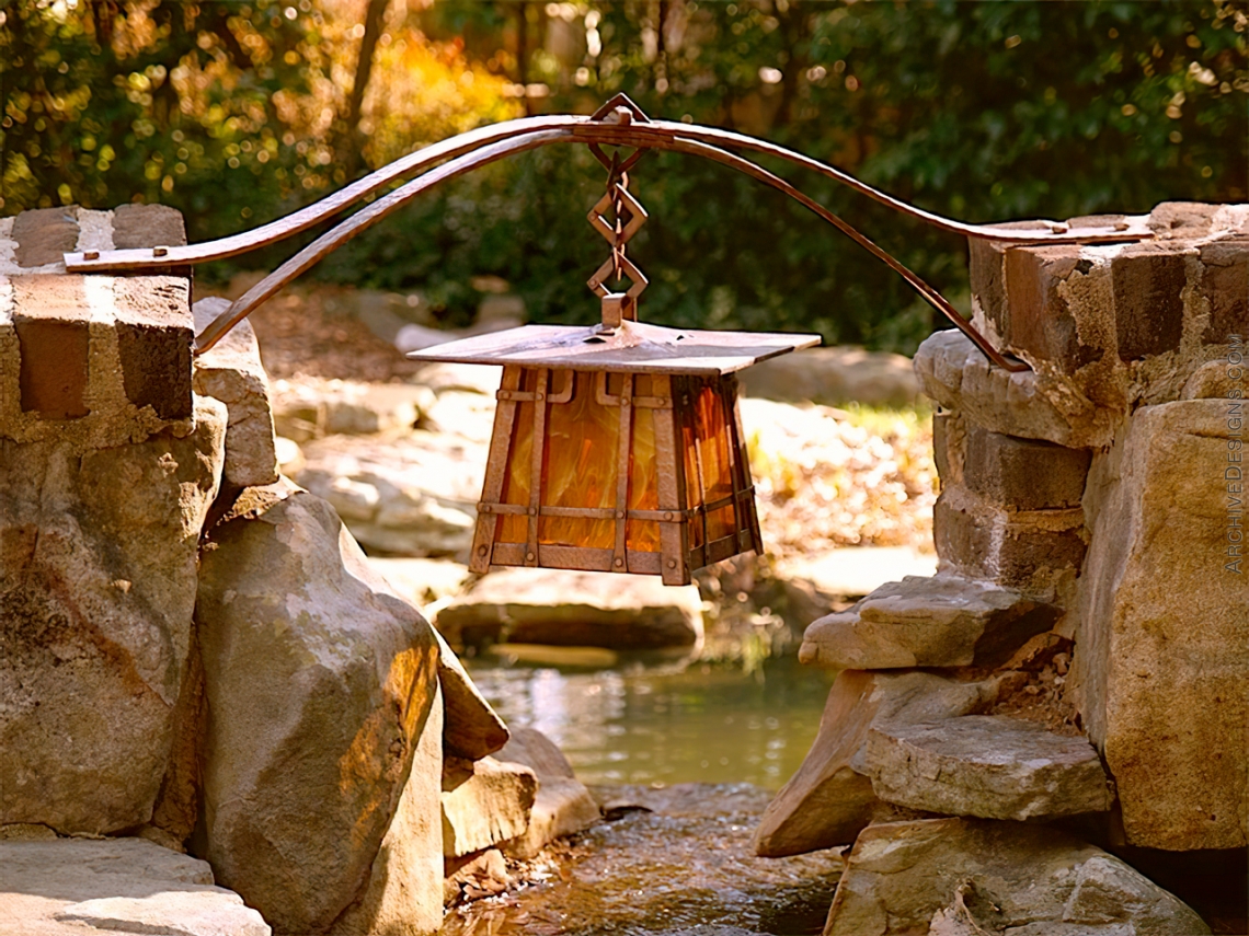 Copper lantern over a pond by Archive Designs